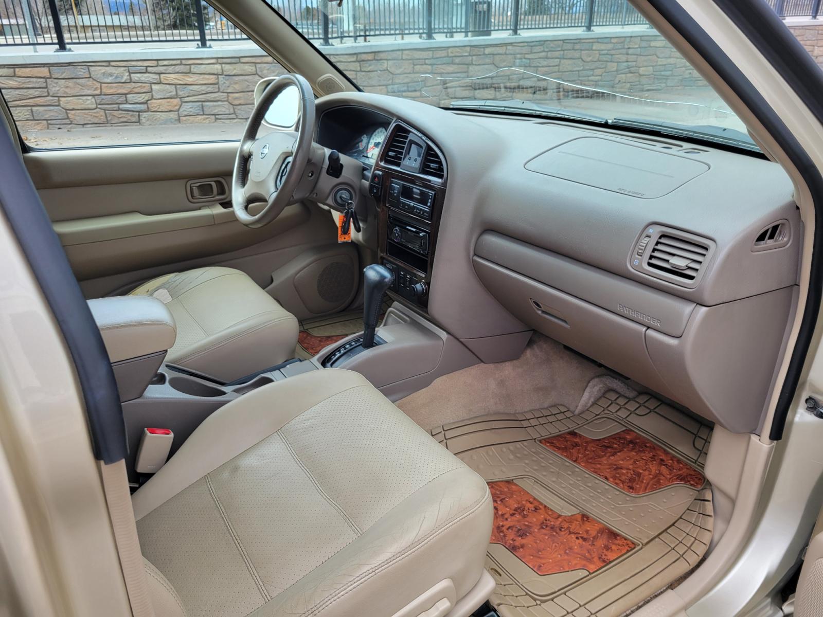2002 Gold /Tan Nissan Pathfinder LE (JN8DR09Y22W) with an 3.5L v6 engine, Automatic transmission, located at 450 N Russell, Missoula, MT, 59801, (406) 543-6600, 46.874496, -114.017433 - 4WD SUV. 3.5L V6. Automatic Transmission. Heated Seats. Power Leather Seats. Power Sunroof. Air. Cruise. Tilt. AM FM CD Player. Power Windows and Locks. Because of the age, Financing is not available on this vehicle. - Photo #9